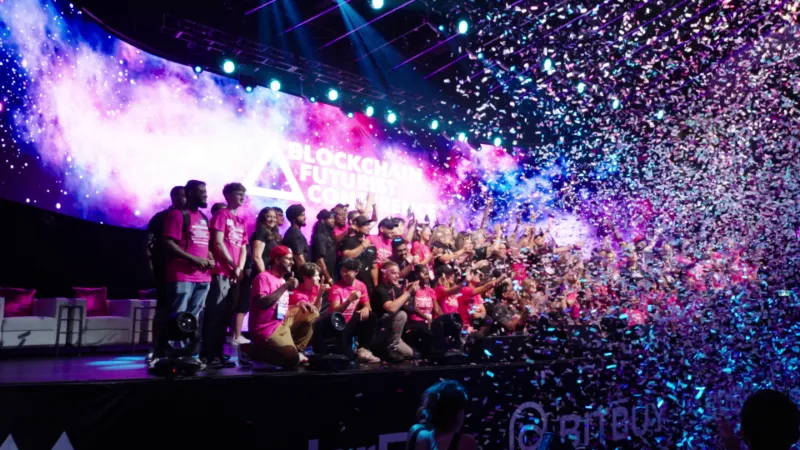 Confetti falling over the stage and crowd at a conference event